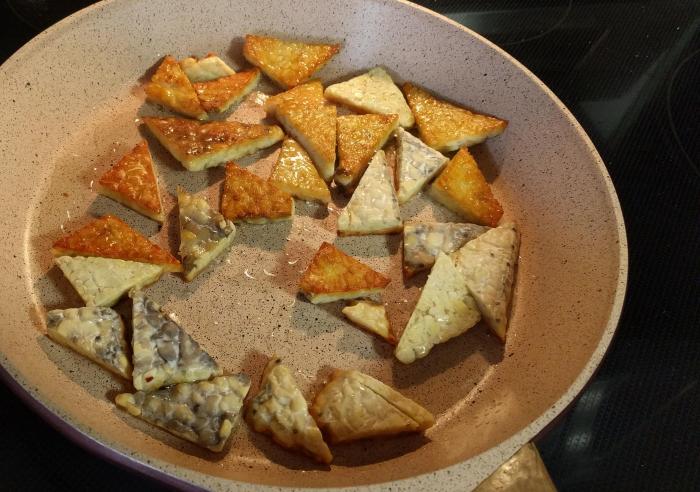 Frying tempeh in olive oil on stove