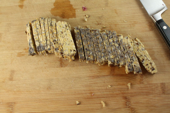 Sliced tempeh that has blackness on its top from the fermentation process